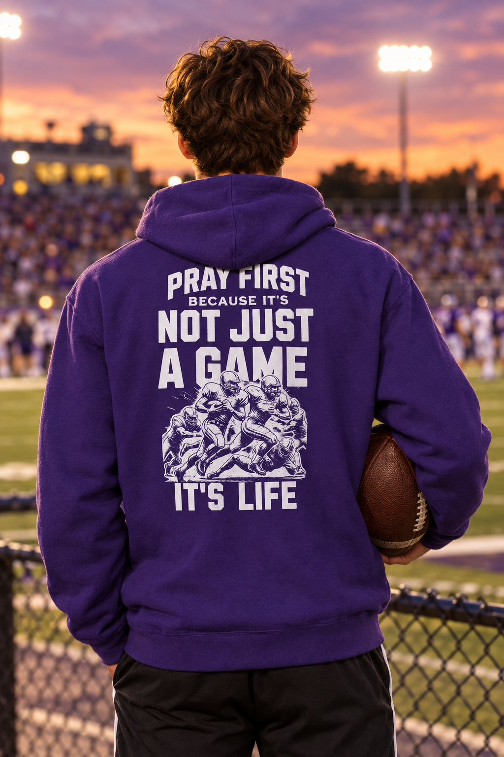 Athlete in purple Roll Dawgs hoodie holding a football on the sidelines
